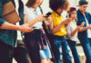 Backdoor Vote Revives EU Chat Scans Group of young people looking at smartphones