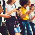 Backdoor Vote Revives EU Chat Scans Group of young people looking at smartphones