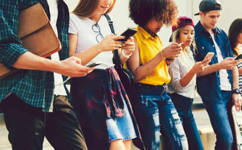 gen-z1101247694 Group of young people looking at smartphones
