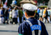 Horrifying Lip-Stitch Mystery Grips Japan Police officer monitoring a crowd at an outdoor event