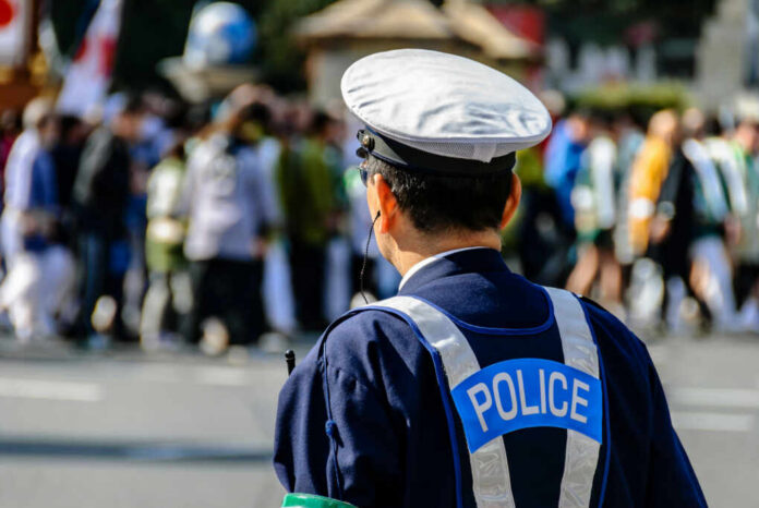 Police officer monitoring a crowd at an outdoor event