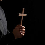 Prayed, Then Gone — Nicaragua’s Chilling Move Clergyperson holding a wooden cross