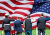 Overlooked VA Benefit Rescues Grieving Families Veterans salute a large American flag