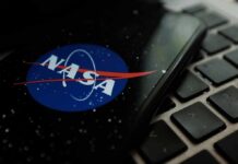 NASA logo on smartphone resting on a laptop keyboard