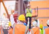 construction workers raising fists during a safety briefing