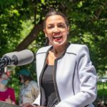Wrong Messenger? Dems Panic Quietly Woman speaking at an outdoor podium with a microphone