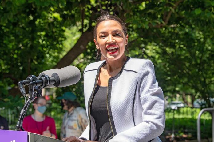 shutterstock_1986192140 Woman speaking at an outdoor podium with a microphone