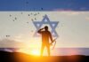 silhouetted soldier saluting at sunset with star symbol overlay
