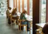 Rigged Med School Track Allegedly Exposed Students studying at long tables by large library windows