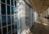 Retaliation Rampage Inside Mississippi Jail Interior view of a prison corridor with jail cells and sunlight streaming through windows