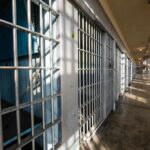 Retaliation Rampage Inside Mississippi Jail Interior view of a prison corridor with jail cells and sunlight streaming through windows