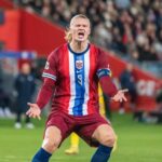Haaland Mania Hits Peru’s Birth Certificates Soccer player in Norway kit shouting with arms outstretched