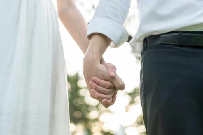 Couple holding hands outdoors