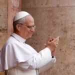 Pope clapping and smiling during a public appearance