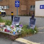 Racism Lie Flips Script—Victim Treated As Thug Three police officers in high-visibility jackets stand facing a busy street