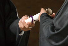 Graduation Gatekeeper: AI Now Calls The Shots Two individuals exchanging a diploma during a graduation ceremony