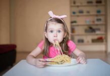 Free Pasta Sparks Voter ID Brawl Girl eating spaghetti at a table