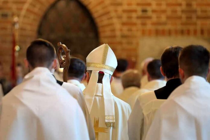 Bishop in white mitre among clergy during church procession