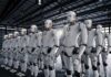 Robots Gut Unions — Prices Climb Next Rows of humanoid robots standing in a warehouse