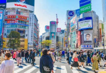 Foreign Agents Beware—Tokyo Moves Crowded Shibuya crossing with colorful advertisements buildings