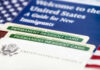 DHS Rewrites ‘Public Charge’—Chaos Ahead U.S. permanent resident cards with immigration guide and flag