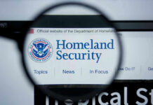 Fines Follow Them Home — DHS Goes Global Magnifying glass showing Homeland Security website.