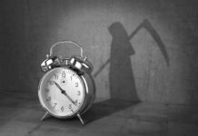 alarm clock with grim reaper shadow