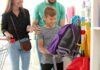 School Supplies SURGE — Wallets Scream Boy choosing a purple backpack in a store with adults nearby