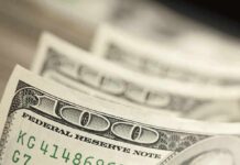 Warsh Yanks The Crutch—Markets On Their Own Stack of U.S. hundred dollar bills in close-up