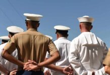 sailors and marines standing in formation with hands behind backs