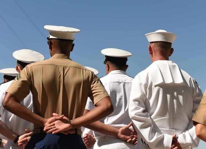 shutterstock_1210061623 sailors and marines standing in formation with hands behind backs