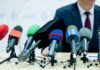 Affair Allegation Ambush Hits Paxton microphones clustered on a table at a press conference