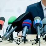 Affair Allegation Ambush Hits Paxton microphones clustered on a table at a press conference