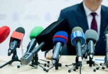Affair Allegation Ambush Hits Paxton microphones clustered on a table at a press conference