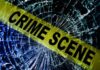 Crime scene tape over shattered glass