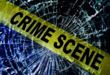 Crime scene tape over shattered glass