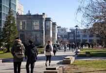 students walking on a university campus pathway