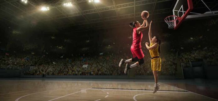 shutterstock_1411326926 Two basketball players contest a layup under the hoop