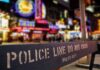 $2,500 Fix? Extortion Whiff Hits NYPD — Business Destroyed Police barrier with city nightlife in the background