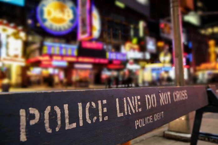 Police barrier with city nightlife in the background