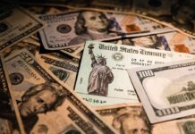 COVID Loot Fuels Mortgages, Campaign — Mayor Nabbed United States Treasury check on a pile of US dollar bills