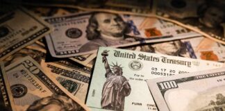 United States Treasury check on a pile of US dollar bills