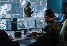 Military analysts at computers in a command center