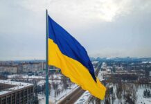 Ukrainian flag over snowy cityscape
