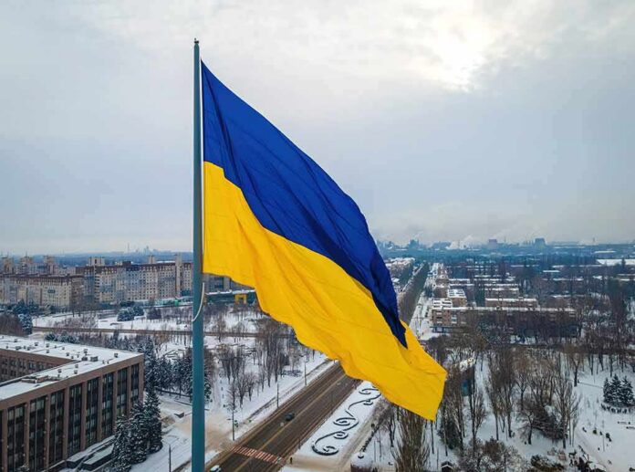 Ukrainian flag over snowy cityscape