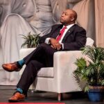 Religion Jab? CNN Grills Tim Scott Man in suit seated in white armchair on stage