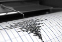 Seismograph needle recording earthquake waves on paper