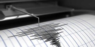 Seismograph needle recording earthquake waves on paper