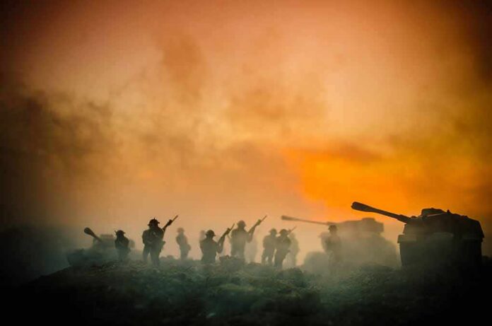 shutterstock_686756764 Toy soldiers and tanks silhouetted against an orange smoky sky
