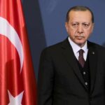 New Military Bloc Forms In Mecca man in suit standing beside Turkish flag